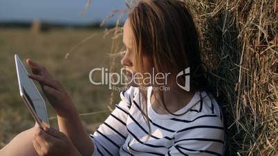 Young woman with touch pad in the countryside