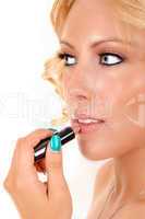 Woman putting lipstick on.