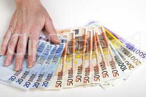 Hand fans out euro bills