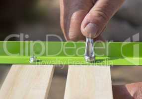 Screw the wooden slats of metal rail
