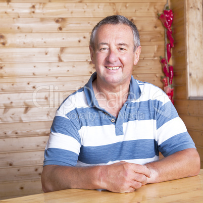 Man sitting on rustic table Man sitting on rustic table