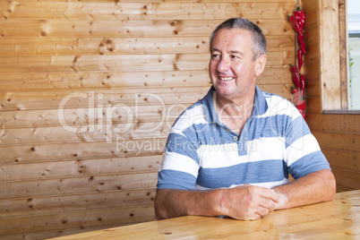 Man sitting on rustic table Man sitting on rustic table
