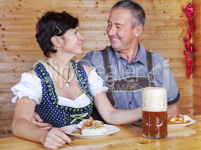 Man and woman in bavarian costume at the snack