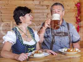 Man and woman in bavarian costume at the snack
