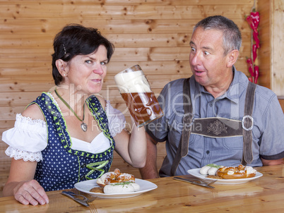 Man and woman in bavarian costume at the snack