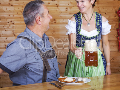 Man and woman in bavarian costume at the snack