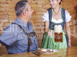 Man and woman in bavarian costume at the snack