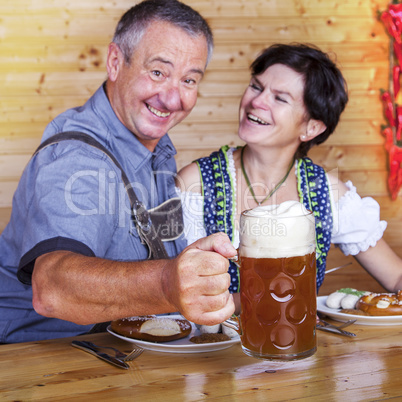 Man and woman in bavarian costume at the snack