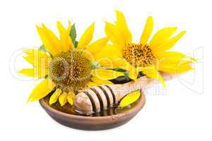 clay dish with honey drizzler and flowers sunflowers