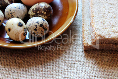 plate with eggs of the quail and piece of bread