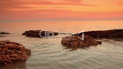 Stones in a Calm Sea after Sunset. Seamless Looped