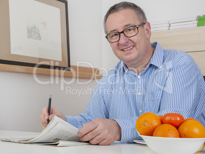 Man reading the newspaper in his spare time