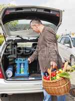 Man lifts Basket water tank in the car