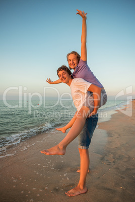 Boy and girl playing on the beach