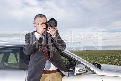 Man standing in front of the car and photographed