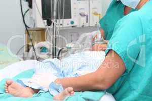 Assistant preparing a child for a surgery
