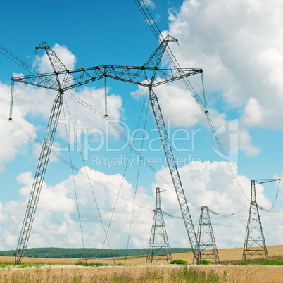 Power transmission line on a background of the cloudy sky