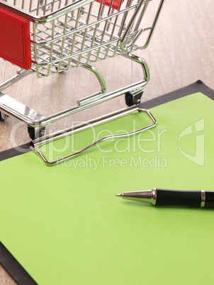 Blank notepad with a shopping cart
