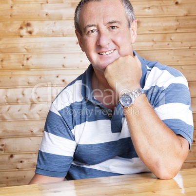 Man with head propped sitting at the table