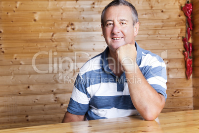 Man with head propped sitting at the table