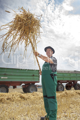 Farmer with pitchfork when shipped from straw