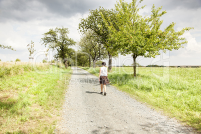 Woman taking a walk on the dirt road
