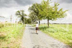 Woman taking a walk on the dirt road