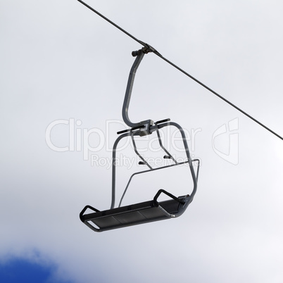 Chair-lift and cloudy sky