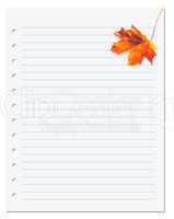 Notebook paper with orange autumn maple leaf on white