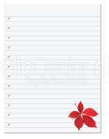 Notebook paper with red autumn virginia creeper leaf in corner