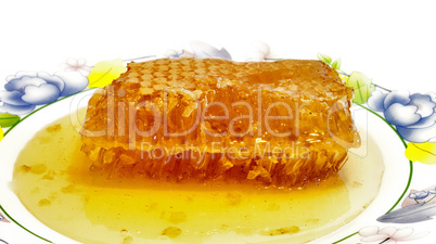 Fresh honey with honeycomb .