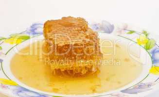 Fresh honey with honeycomb .