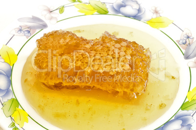 Fresh honey with honeycomb .