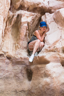 Girl sitting on a rock.