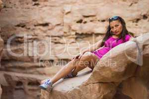 girl sitting on a rock
