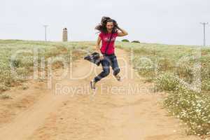 Happy beautiful woman is jumping .