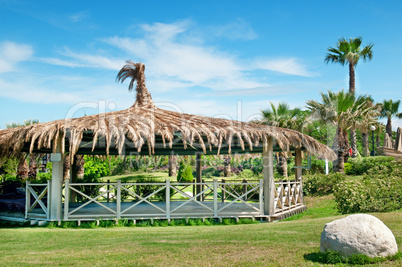 outdoor pavilion, lawn and palm trees