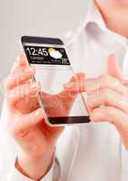 Smartphone with transparent screen in human hands.