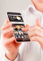 Smartphone with transparent screen in human hands.