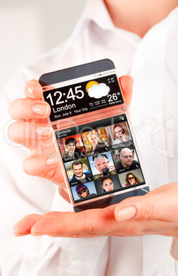 Smartphone with transparent screen in human hands.