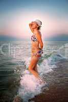 Young woman in the sea waves