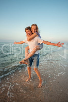 Boy and girl playing on the beach