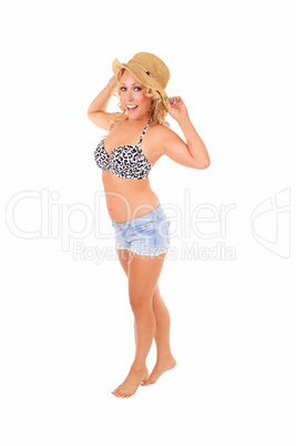 Woman in shorts and hat.