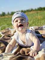 one kid sitting on the grass