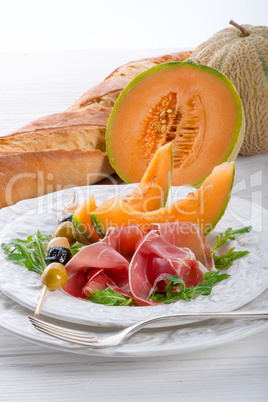 Ham with melon and olives