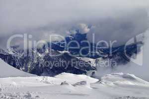 Winter snowy mountains in clouds