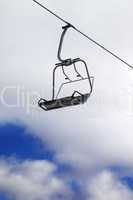 Chair-lift and cloudy sky