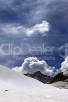 Rocks with clouds and snowy plateau
