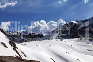 Snow rocks and cloudy blue sky