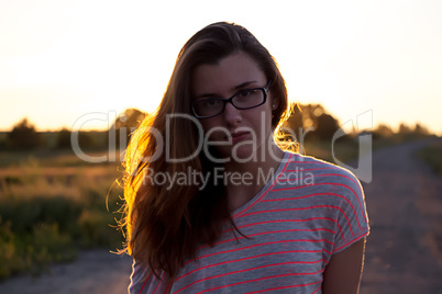 Beautiful teenager girl in the light of sunset